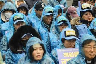 Family members of victims of South Korea's deadliest plane crash on home soil gather for a rally in Seoul on December 20, 2025, ahead of the first anniversary of the December 29, 2024 Air Jeju plane crash, when a Boeing 737-800 was flying from Thailand to South Korea's southwest but ended up belly-landing at Muan airport and exploding in a fireball after slamming into a concrete structure, killing 179 people. (Photo by ANTHONY WALLACE / AFP)