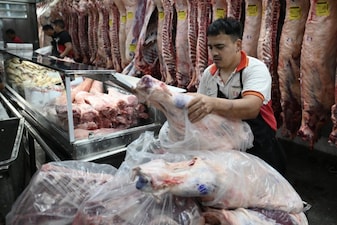 A worker packs beef at  a meat-packing plant in Buenos Aires on December 5, 2025. Along with (AFP)