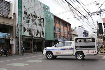 A police vehicle passes by a budget hotel in downtown Davao City, southern Philippines as they assist investigations on where Bondi beach suspects reportedly stayed while in the country in November. File image/AP
