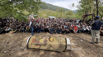 Kashmiri villagers sit next to the coffin of Adil Hussain Shah, who was killed in a terror attack near Pahalgam, before his funeral prayers at his village in Hapatnar in south Kashmir's Anantnag district, India, April 23, 2025. File Image/Reuters