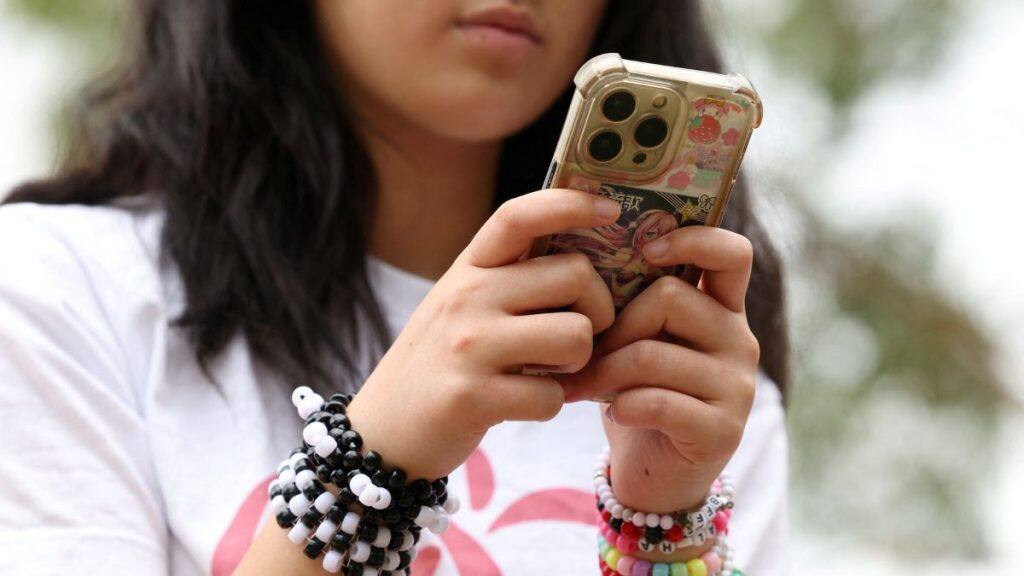 A child poses after an interview discussing Australia’s social media ban for users under 16, which is scheduled to take effect on December 10, in Sydney, Australia, November 22, 2025. File Image/Reuters