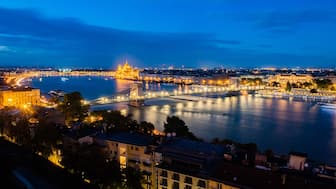 A general view shows the Danube River flowing past the illuminated Hungarian Parliament Building (top) in the Hungarian capital Budapest on September 16, 2024. AFP File
