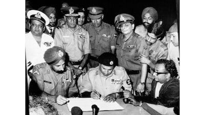 Lieutenant General AAK Niazi of Pakistan Army signs the Instrument of Surrender under the gaze of Lieutenant General Jagjit Singh Aurora at Dhaka, present-day Bangladesh, on December 16, 1971. (Photo: Government of India via Government Open Data License) 