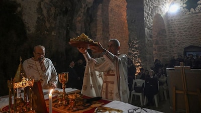 Priests celebrate the Christmas Eve mass at the Church of Saint Peter, where the first religious gathering was held in the 1st century, the birth of Christianity, on December 24, 2025 in Antakya, Turkey. (Photo: Ozan Kose/AFP)