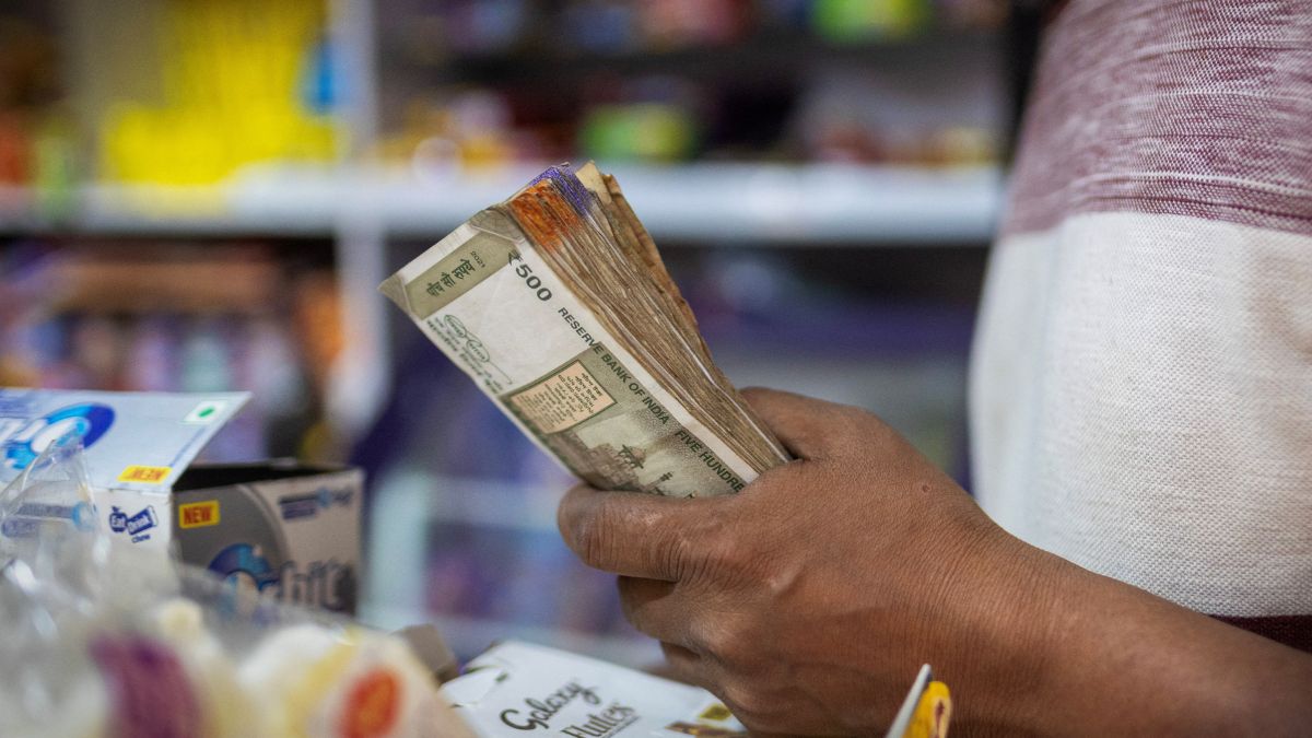 A man holds Indian currency notes inside a shop in New Delhi, India, April 3, 2025. Representational Image/Reuters A man holds Indian currency notes inside a shop in New Delhi, India, April 3, 2025. Representational Image/Reuters