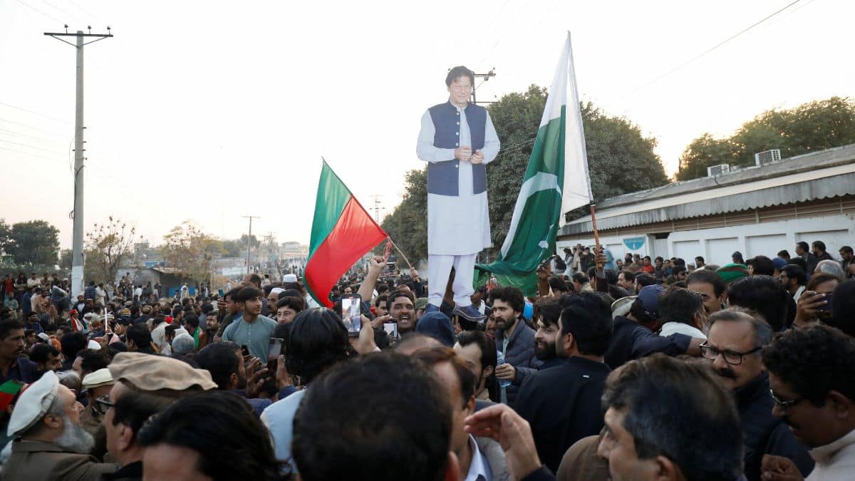 Supporters hold a cutout of former Prime Minister of Pakistan and leader of Pakistan Tehreek-e-Insaf (PTI) party Imran Khan, during a protest over concerns about their leader's health, on a road leading to Adiala jail in Rawalpindi, Pakistan, December 2, 2025. File Image/Reuters