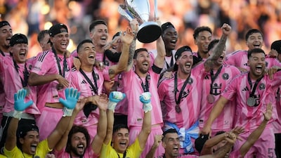 Lionel Messi lifts the MLS Cup along with Inter Miami teammates after starring in their 3-1 victory over Thomas Muller's Vancouver Whitecaps in the final in Fort Lauderadele, Florida on Saturday, 6 December. AP