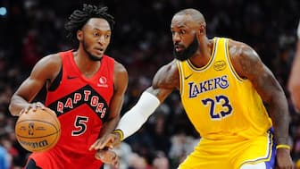 Toronto Raptors' Immanuel Quickley (5) protects the ball from Los Angeles Lakers' LeBron James (23) in the NBA. AP
