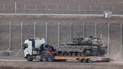 A truck transports a tank on the Israeli side of the border with Gaza, Israel, on November 18, 2025. Reuters File