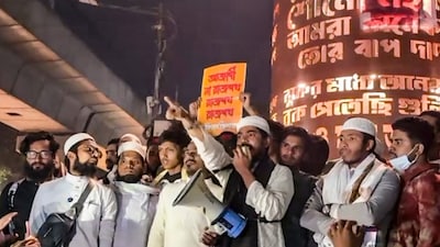 People stage a protest over the death of Sharif Osman Hadi. PTI