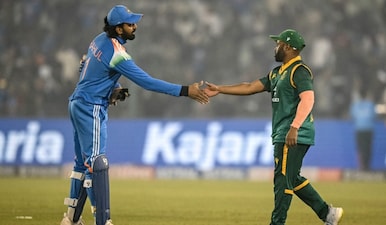 India's captain KL Rahul (L) shakes hands with his South African counterpart Temba Bavuma at the end of the second one-day international (ODI) cricket match between India and South Africa at the Shaheed Veer Narayan Singh International Cricket Stadium in Raipur on December 3, 2025. AFP