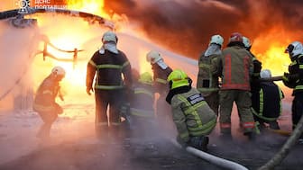 This handout picture taken and released by Ukrainian State Emergency Service on December 7, 2025 shows firefighters working to extinguish a fire following a Russian drone and missile attacks to industrial and energy infrastructures in the Poltava region, amid the Russian invasion in Ukraine.- AFP