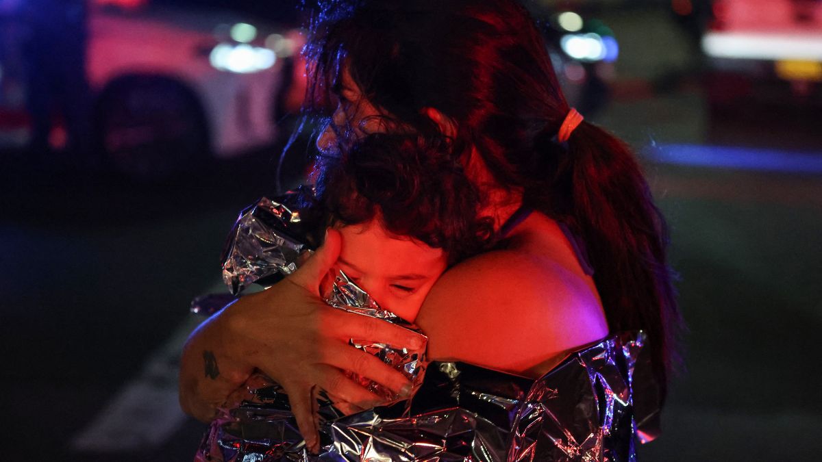 A woman holds her baby in a blanket after a shooting incident at Bondi Beach in Sydney on December 14, 2025.- AFP A woman holds her baby in a blanket after a shooting incident at Bondi Beach in Sydney on December 14, 2025.- AFP