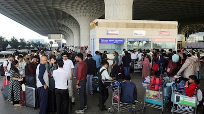 Passengers wait outside the IndiGo airlines ticketing counter at the Chhatrapati Shivaji Maharaj International Airport, after several IndiGo airlines flights were cancelled, in Mumbai, December 5, 2025. Reuters