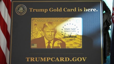 A sign with an image of U.S. President Donald Trump that reads "Trump Gold Card is here" is displayed in the Oval Office at the White House in Washington, DS, US, September 19, 2025. File Photo/Reuters