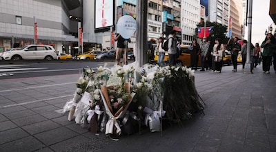 Flowers and notes from the public are laid for the victims of the metro attack outside a mall in Taipei on December 20, 2025. Image Credit: AFP