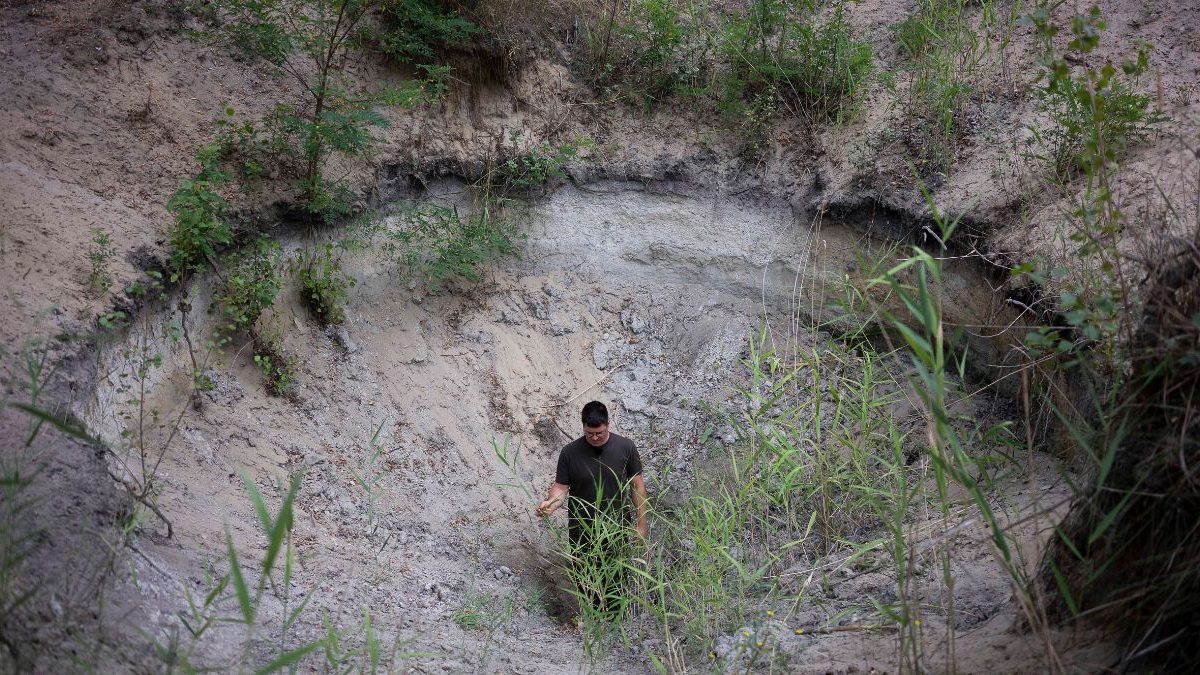 Oszkár Nagyapáti, farmer and member of the volunteer water guardians, stands in a hole in Kiskunmajsa, Hungary, Tuesday, July 29, 2025. Image Credit: AP Oszkár Nagyapáti, farmer and member of the volunteer water guardians, stands in a hole in Kiskunmajsa, Hungary, Tuesday, July 29, 2025. Image Credit: AP