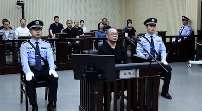 This photo released by the Tianjin No.2 Intermediate People’s Court on May 28, 2024 shows Bai Tianhui (C), the former general manager of China Huarong International Holdings (CHIH), a subsidiary of Huarong Asset Management, during his sentencing at the court on May 28, 2024. AFP
