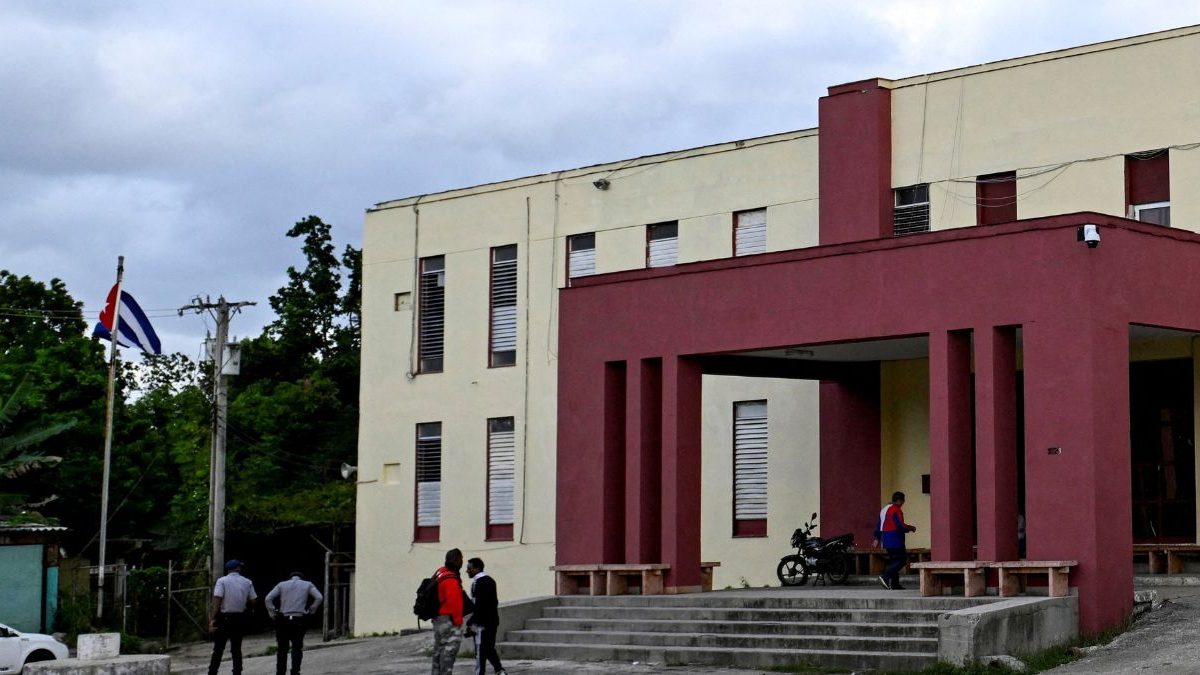 People stand at the entrance of the courthouse where Cuba's former Economy Minister Alejandro Gil stands trial on espionage charges, Havana, Cuba, November 11, 2025. Image Credit: Reuters People stand at the entrance of the courthouse where Cuba's former Economy Minister Alejandro Gil stands trial on espionage charges, Havana, Cuba, November 11, 2025. Image Credit: Reuters