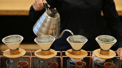 A woman brewing Japanese tea at a tea salon in Tokyo. File photo/AFP