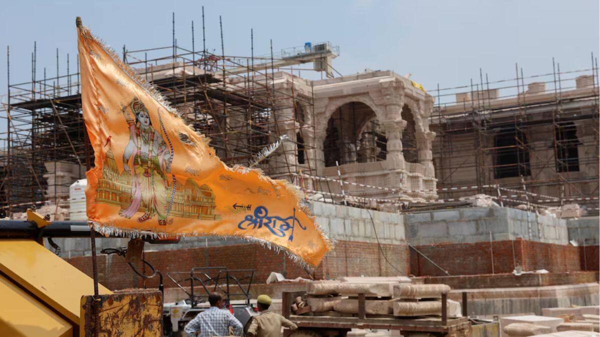 religious flag is seen in front of the under-construction Hindu Ram Temple in Ayodhya in India, July 9, 2023.
