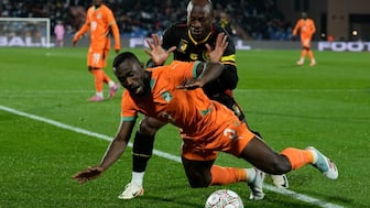 Ivory Coast's Ghislain Konan is challenged by Cameroon's Christian Bassogog during the Africa Cup of Nations group F soccer match between Ivory Coast and Cameroon, in Marrakech, Morocco, Sunday, Dec. 28, 2025. AP