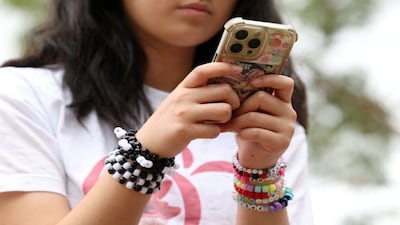 A 14-year-old with her phone. (Photo: Reuters)