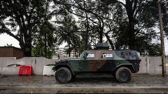 An aromoured vehicle is positioned at the entrance of a blocked road next to the National Television, Benin TV, in Cotonou, on December 08, 2025. (AFP)
