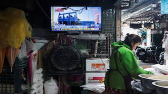 A woman works in a noodle store near a television screen showing a news report on China's "Justice Mission 2025" military drills around Taiwan, in Taipei, Taiwan. Reuters
