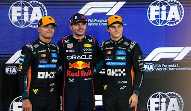 Red Bull driver Max Verstappen of the Netherlands, center, poses with McLaren driver Lando Norris of Britain, who qualified second, left, and McLaren driver Oscar Piastri of Australia, who qualified third, after clocked the fastest time during the qualifying session ahead of the Formula One Abu Dhabi Grand Prix at the Yas Marina Circuit in Abu Dhabi, UAE, Saturday, Dec. 6, 2025. AP