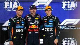 Red Bull driver Max Verstappen of the Netherlands, center, poses with McLaren driver Lando Norris of Britain, who qualified second, left, and McLaren driver Oscar Piastri of Australia, who qualified third, after clocked the fastest time during the qualifying session ahead of the Formula One Abu Dhabi Grand Prix at the Yas Marina Circuit in Abu Dhabi, UAE, Saturday, Dec. 6, 2025. AP