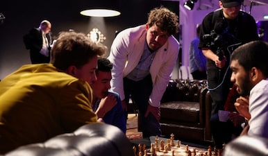 Chess Grandmaster Magnus Carlsen reviews the strategy with chess grandmaster and World Champion Gukesh Dommaraju and Vincent Keymer during the Freestyle Chess Grand Slam Tour in Paris, France, April 7, 2025. Reuters