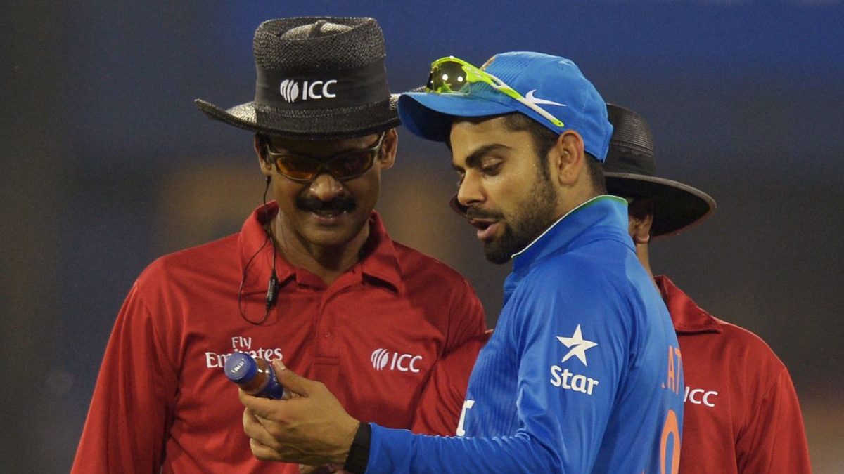 Virat Kohli shows a bottle thrown in the ground to the umpires. Image: AFP Virat Kohli shows a bottle thrown in the ground to the umpires. Image: AFP