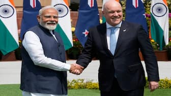 Prime Minister Narendra Modi greets New Zealand Prime Minister Christopher Luxon in New Delhi. The two countries have announced a FTA, which enhances market access and tariff preferences for Indian exports to New Zealand. File image/AP