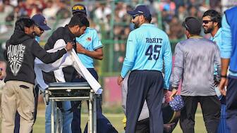 Angkrish Raghuvanshi being attended by Rohit Sharma and others after an injury. Image: PTI