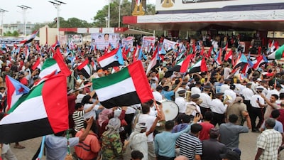 Supporters of the UAE-backed separatist Southern Transitional Council (STC) wave flags of the United Arab Emirates and of the STC, during a rally in Aden, Yemen. Reuters