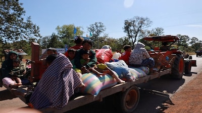 People flee amid clashes between Thailand and Cambodia along a disputed border area, in Oddar Meanchey Province, Cambodia. Reuters