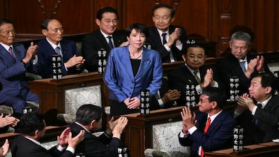 Liberal Democratic Party (LDP) President Sanae Takaichi stands up to acknowledge the applause after she was selected as Japan's new prime minister during an extraordinary session of the lower house of parliament in Tokyo on October 21. AFP