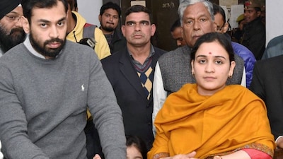 Aparna Yadav (SP), daughter-in-law of Mulayam Singh Yadav, filling her nomination papers for UP Assembly Election in Lucknow in 2017. Her husband (L) Prateek Yadav looks on. File Photo/PTI