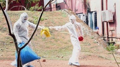 Health officials clear waste from isolation ward of Ernakulam Medical College, in Kerala's Kochi, following detection of the Nipah virus, June 5, 2019. File Photo/PTI