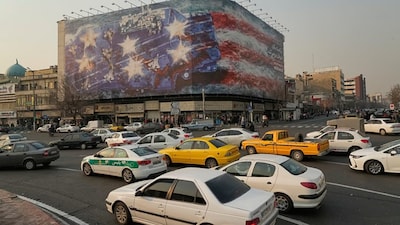A billboard with a damaged aircraft carrier with damaged fighter jets, strewn bodies, and trails of blood in Enghelab Square in Tehran, Iran, Jan. 25, 2026. AP