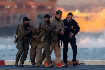 Captured Venezuelan President Nicolas Maduro and his wife Cilia Flores are escorted, as they heads towards the Daniel Patrick Moynihan United States Courthouse in Manhattan for an initial appearance to face U.S. federal charges including narco-terrorism, conspiracy, drug trafficking, money laundering and others, at Downtown Manhattan Heliport, in New York City, U.S., January 5, 2026. REUTERS/Adam Gray