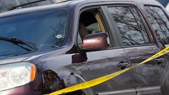 The ICE official allegedly shot through the windscreen of Good's car while sh was trying to back out.  The bullet was shot directly at her face. Police tape is seen around a vehicle with a bullet hole the windshield in Minneapolis. Reuters