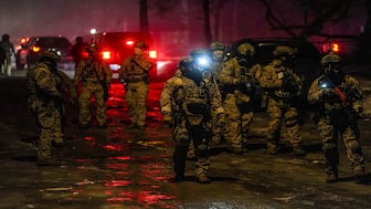 Members of law enforcement gather as tensions rise after federal law enforcement agents were involved in a shooting incident a week after a US Immigration and Customs Enforcement (ICE) agent fatally shot Renee Nicole Good in north Minneapolis, Minnesota, US, on January 14, 2026. (Photo: Ryan Murphy/Reuters) 