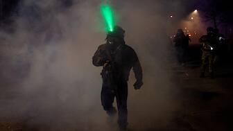 A member of federal law enforcement walks through tear gas after using the chemical on angered community members, as tensions rise after federal law enforcement agents were involved in a shooting incident, a week after a US Immigration and Customs Enforcement (ICE) agent fatally shot Renee Nicole Good, in Minneapolis. Reuters
