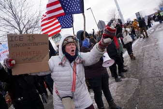 A demonstrator holds a sign, in front of the Bishop Henry Whipple Federal Building, during a protest more than a week after a US Immigration and Customs Enforcement (ICE) agent fatally shot Renee Nicole Good, in Minneapolis, Minnesota, US. Reuters