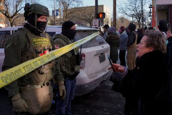 Federal agents stand behind police tape as people gather near the site where a man identified as Alex Pretti was fatally shot by federal agents trying to detain him in Minneapolis, Minnesota, US. File image/Reuters
