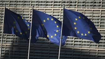 This photograph shows European Union flags outside the Berlaymont building, the headquarters of the European Commission, in Brussels. AFP