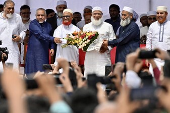 Bangladesh's Jamaat-e-Islami party leader Ameer Shafiqur Rahman (centre right) presents a floral wreath to leader A.T.M. Azharul Islam (centre left) after his release from prison in Dhaka on May 28, 2025. File image/AFP