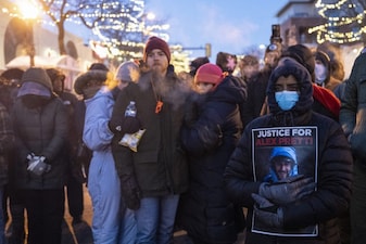 People mourn at a makeshift memorial in the area where 37-year-old Alex Pretti was shot dead by federal immigration agents earlier in the day in Minneapolis, Minnesota, on January 24, 2026. Federal immigration agents shot dead a man in Minneapolis on Saturday, in the second fatal shooting of a civilian during the Trump administration's unprecedented operation in the city, sparking fresh protests and outrage from state officials. The death came less than three weeks after US citizen Renee Good was shot and killed by an ICE officer. (Photo by ROBERTO SCHMIDT / AFP)